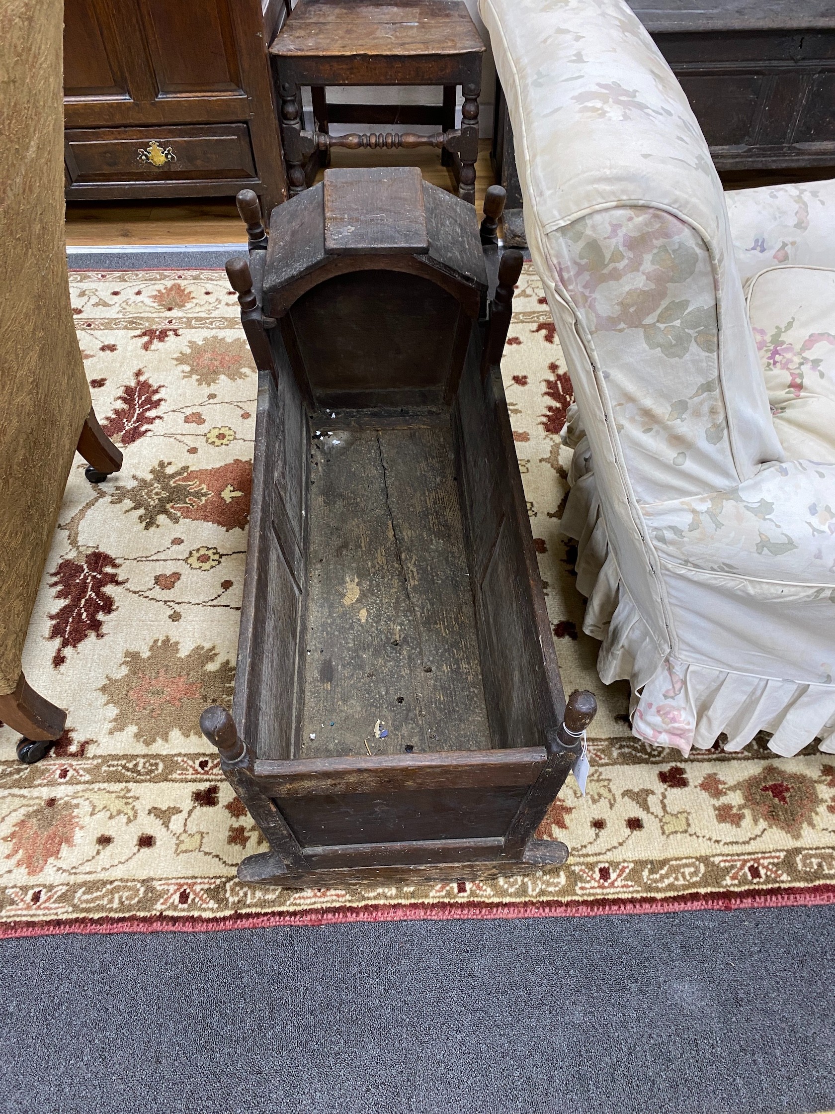 An 18th century oak rocking cradle, with hinged canopy, length 92cm, width 38cm, height 56cm